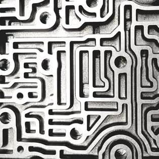 Macro photo of an automatic transmission valve body showing cast aluminium channels